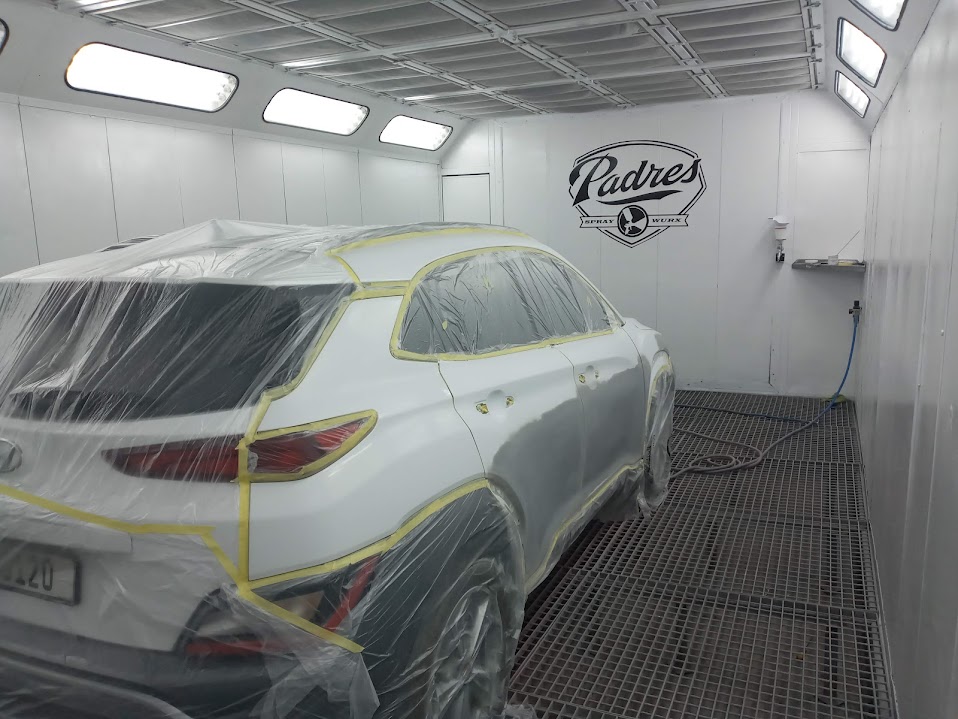 White SUV in Padres Spray Wurx booth - rear view