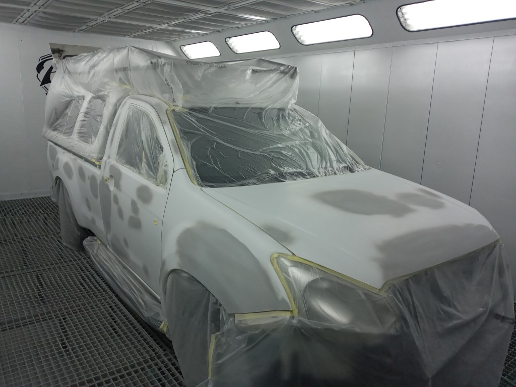 Car being masked for painting